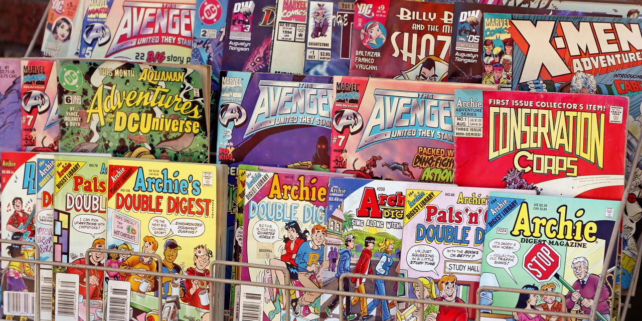 Comics for sale on a news stand.