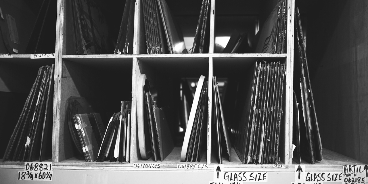 Glass plate negatives / positives in shelved storage.