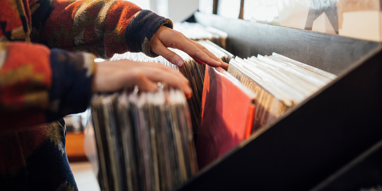 Person searching through a record collection.