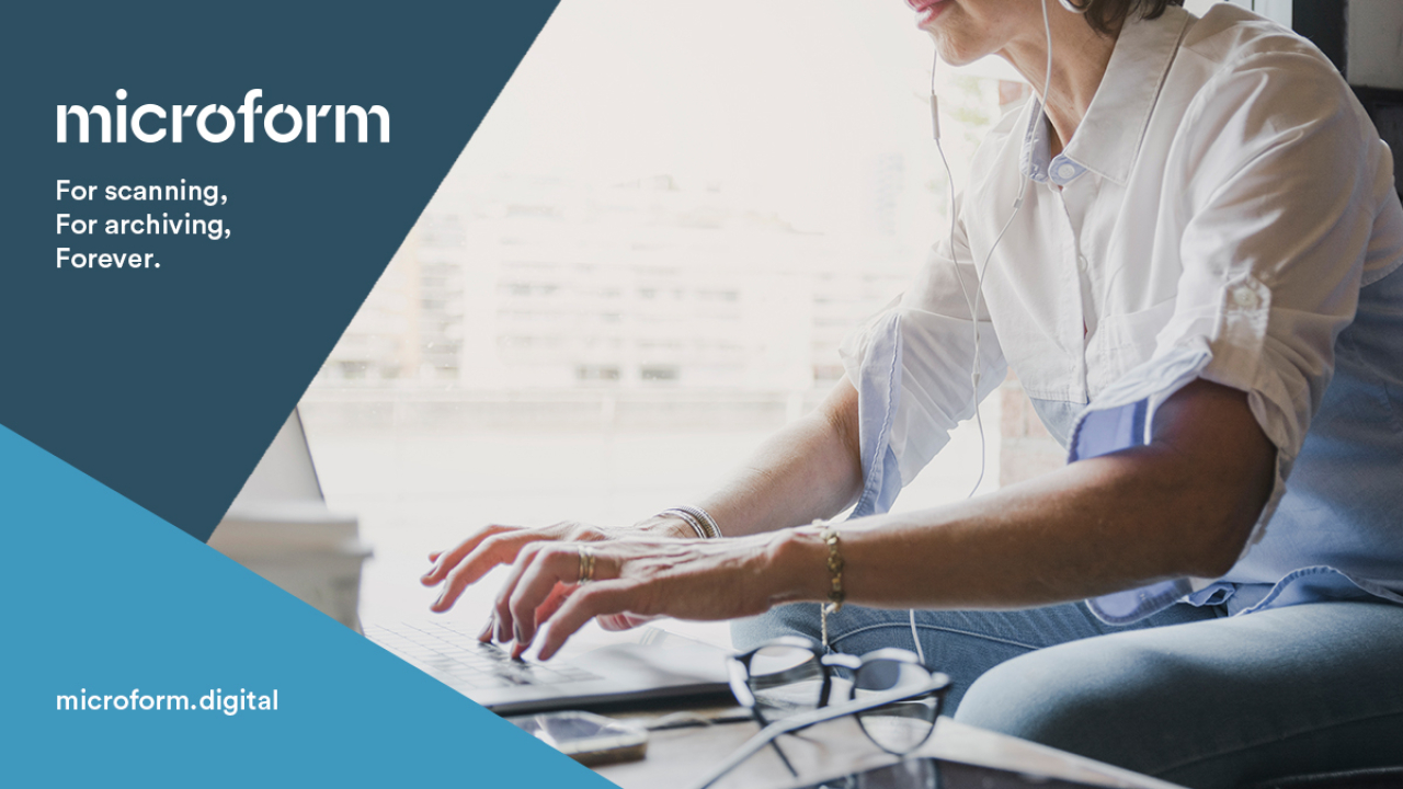 Microform Branding - Woman in causal clothing working on a laptop.